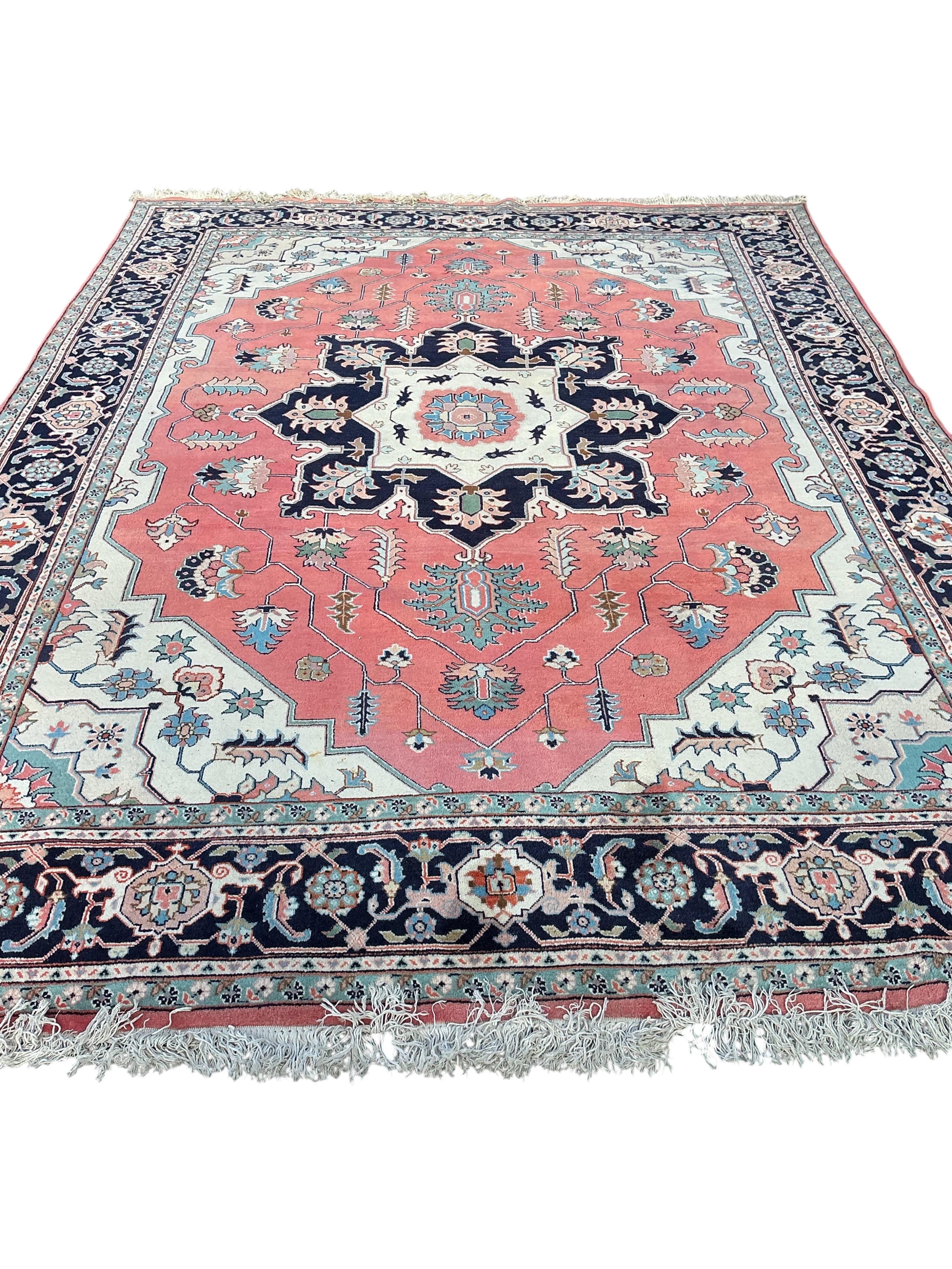 A Heriz brick red ground carpet, 360 x 266cm
